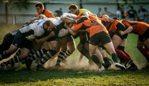 Rugby team tackling for the ball.